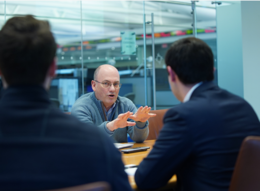 Steve Cohen speaking to two people in conference room
