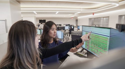 two people working at computer