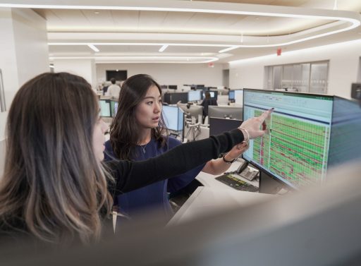 two people working at computer