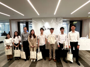 Young men and women in an office holding tote bags